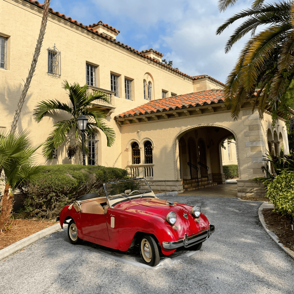 red Historic Crosley Car in front of the Powel Crosley Estate mansion