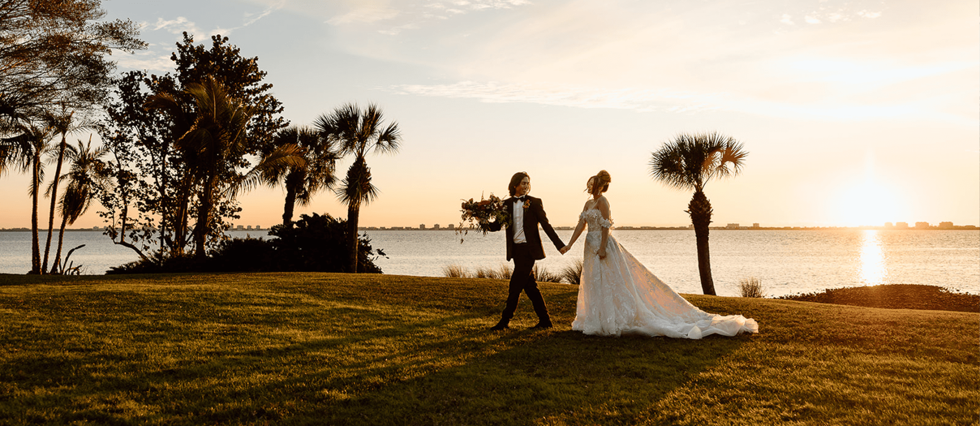 bride and groom at sunset with view of sarasota bay