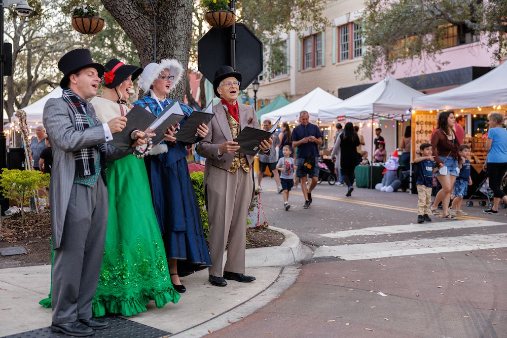 Carolers performing at festive event.