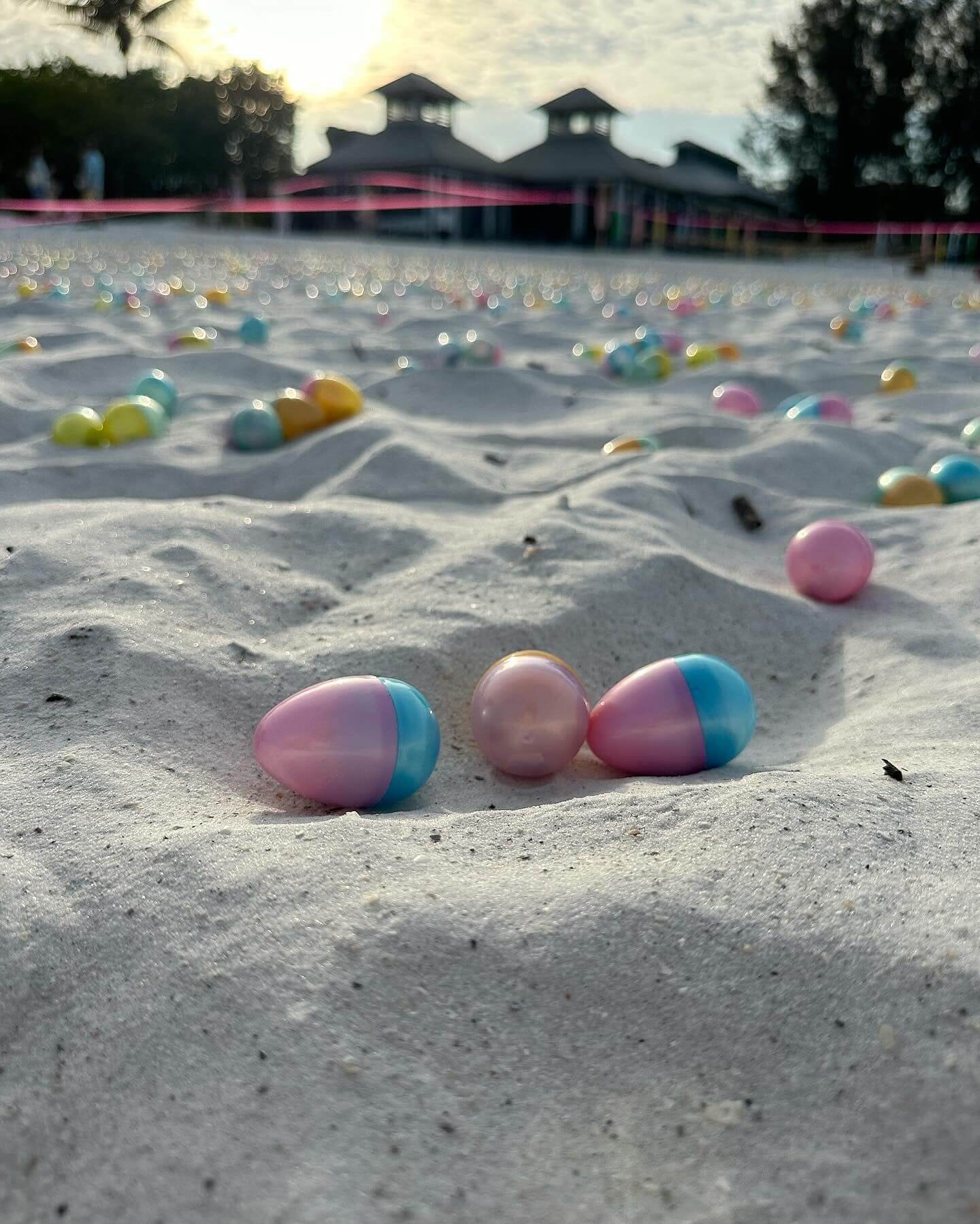 plastic easter eggs in the sand before a hunt in front of the Sandbar Restaurant