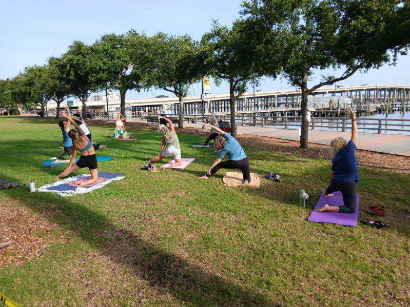 women doing yoga on the bradenton riverwalk
