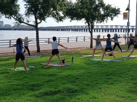 women doing yoga on the bradenton riverwalk