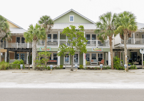 exterior of green key west-style home building on Pine Avenue