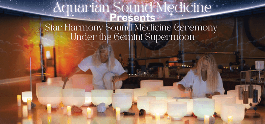 Picture of Aquarian Sound Medicine making healing sounds with different sized crystal bowls.