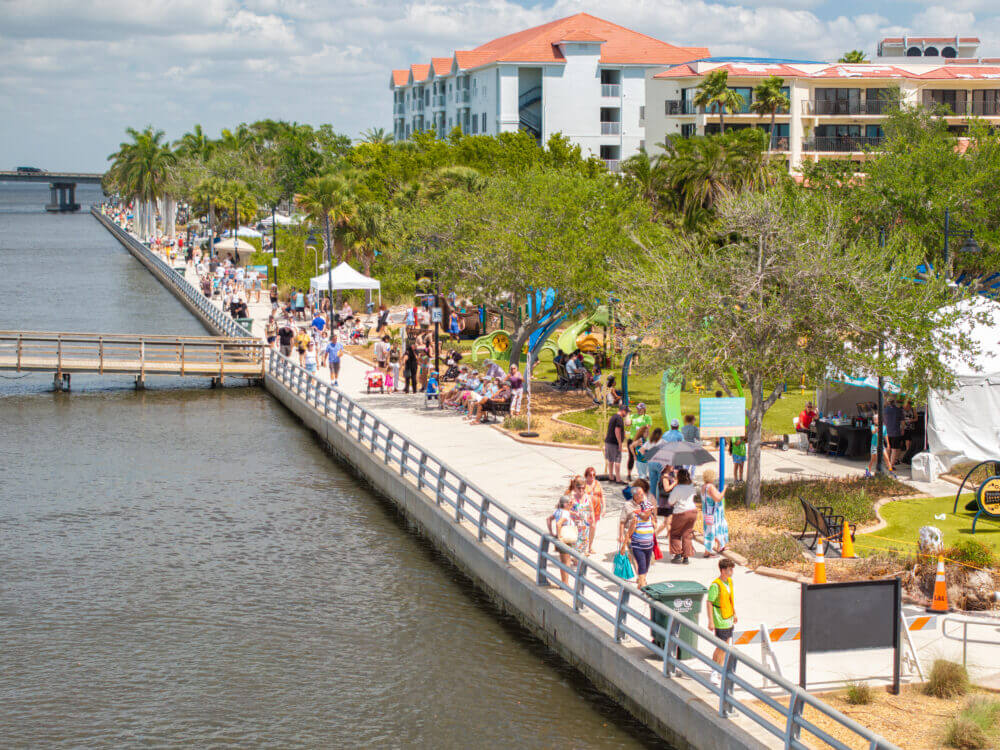 Lively waterfront festival with attendees.
