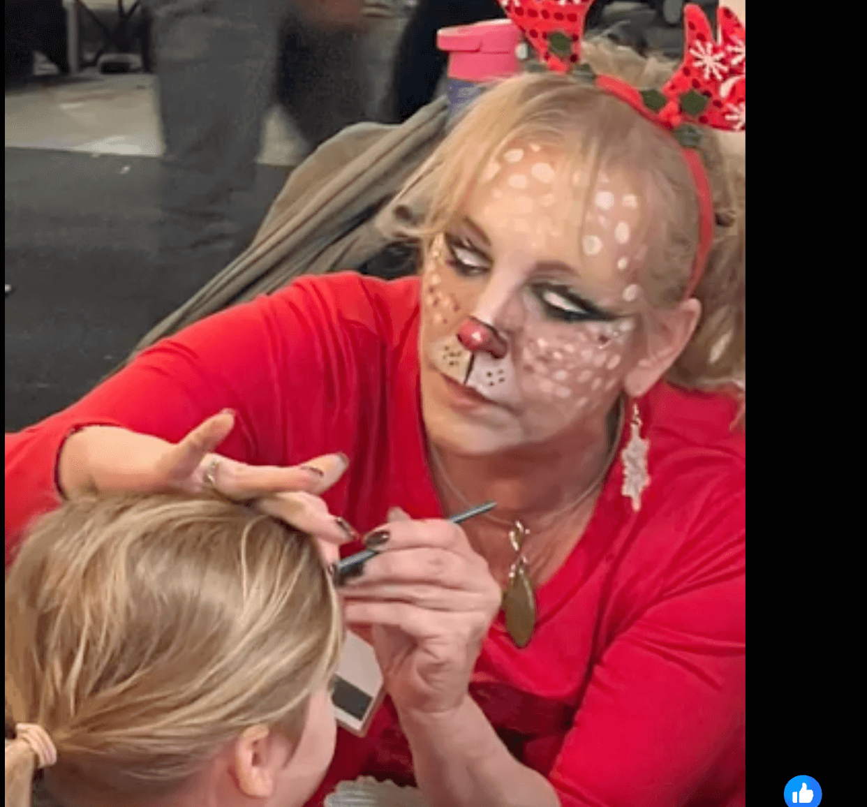 Artist face painting a child's face