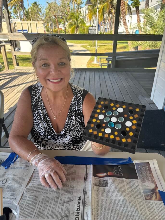 Picture of woman holding a mosaic creation - Florida Maritime Museum