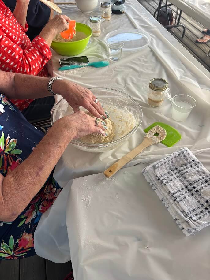 Picture of hands working on sourdough in bowl - Florida Maritime Museum