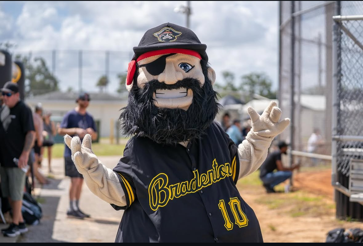 Marty, in black #10 jersey, in a community baseball park