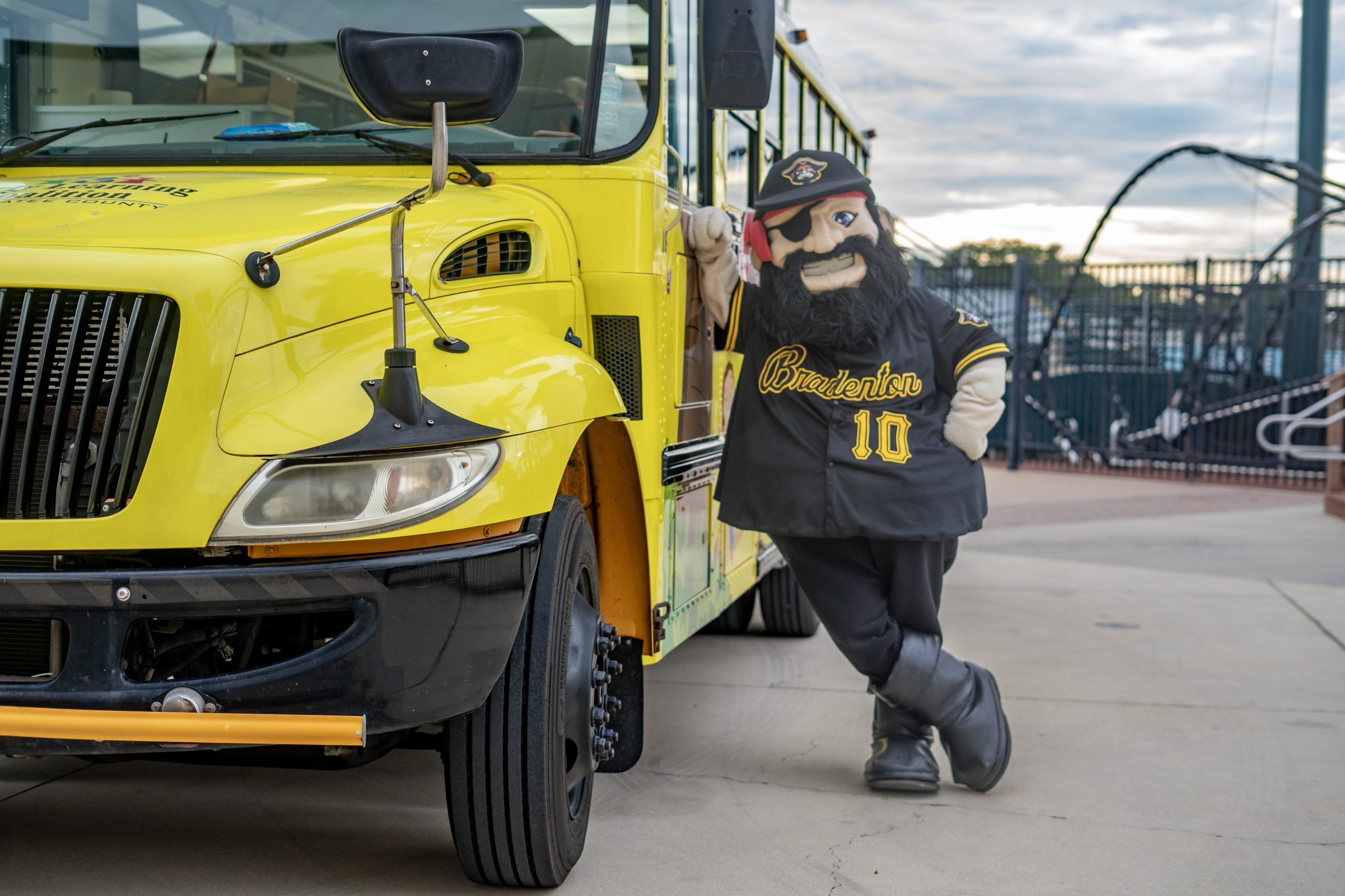 Marty, in black #10 jersey, leaning against school bus driver door