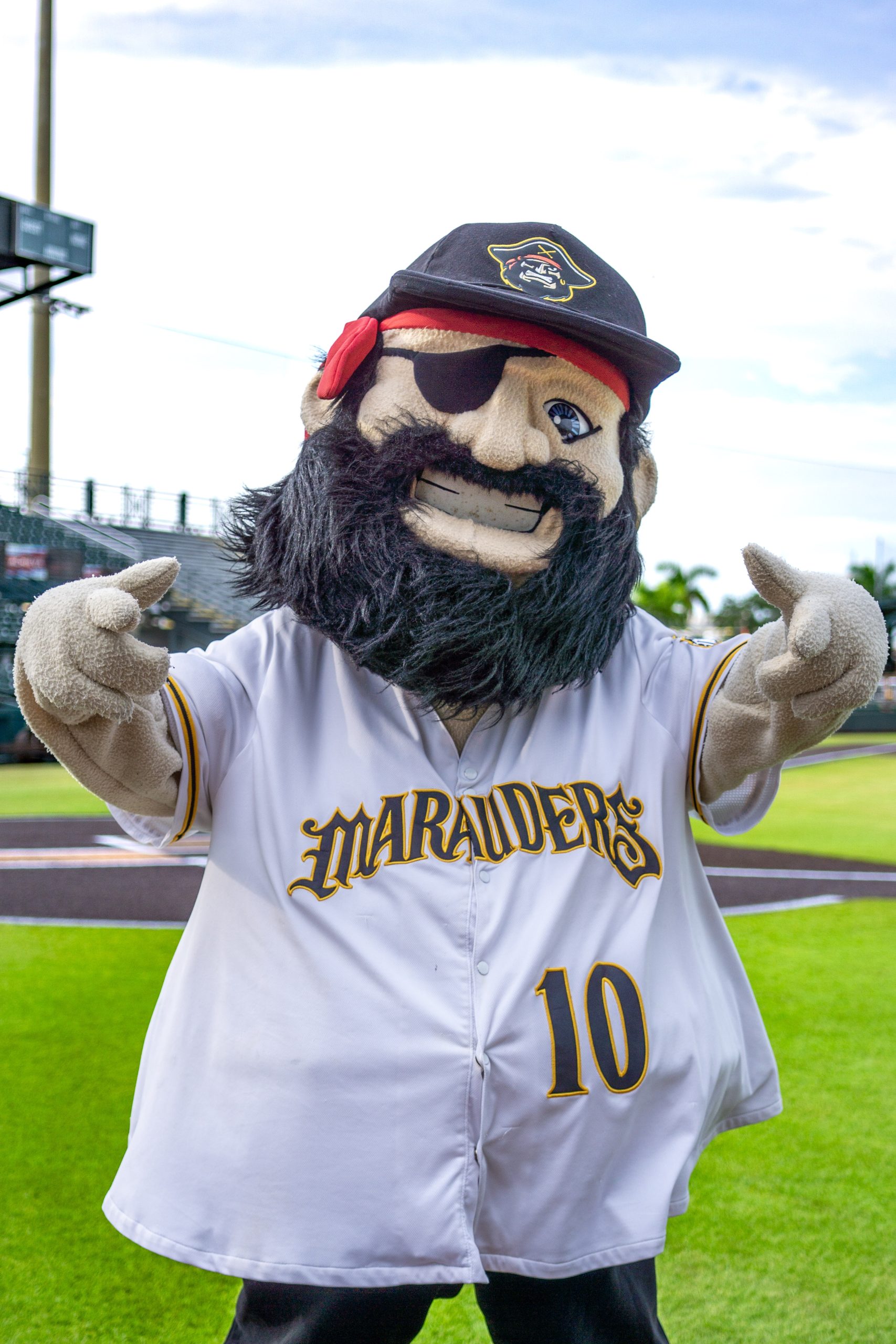 Marty, in a white #10 jersey, standing on the field with his arms up pointing at you