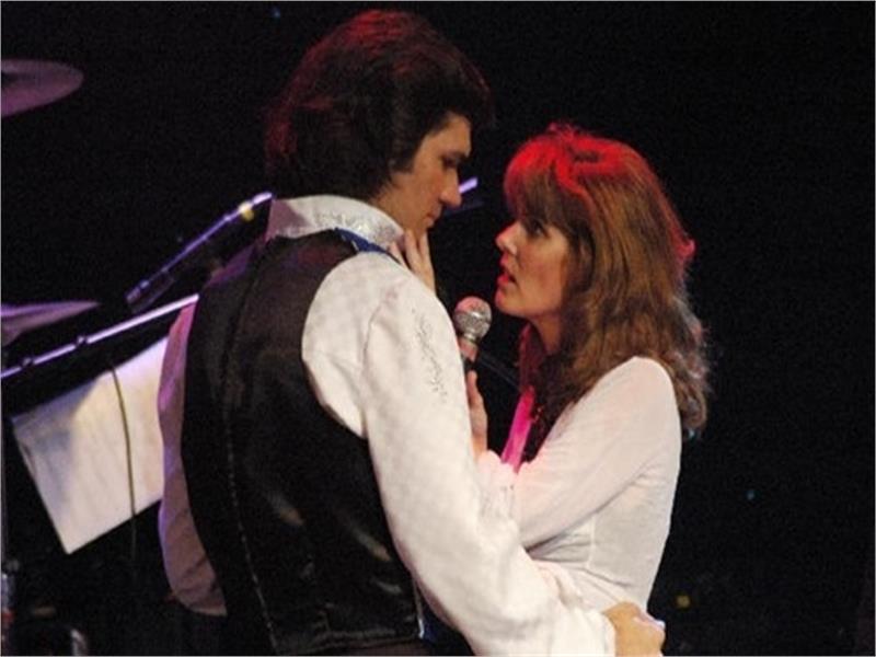 Image of man and woman embracing during performance