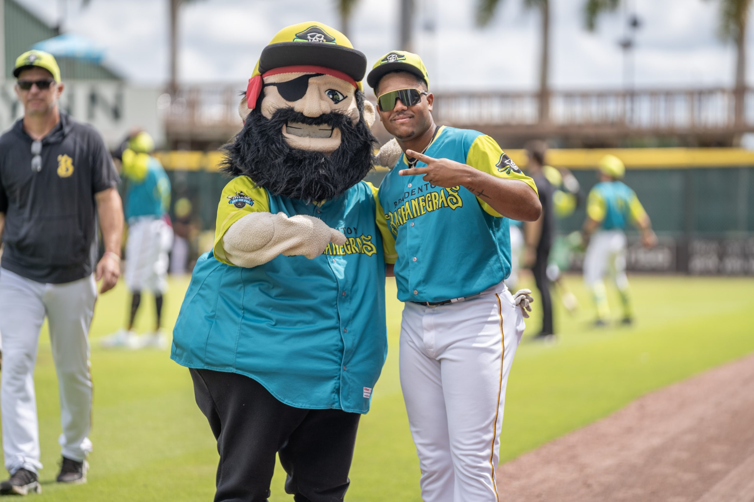 Marty, in a teal & lime Barbanegras jersey, in photo with a team member