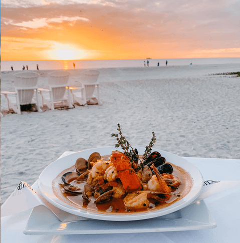 seafood dish at sunset on the beach at Beach Bistro