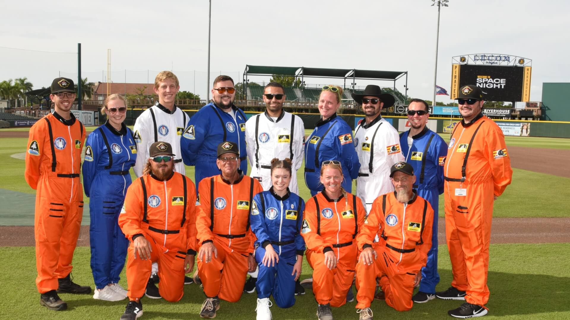 Bradenton Marauders game attendees on the field in astronaut suits