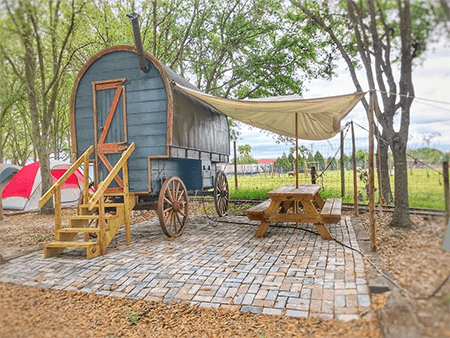 covered wagon accommodations at Hunsader Farms KOA Campground