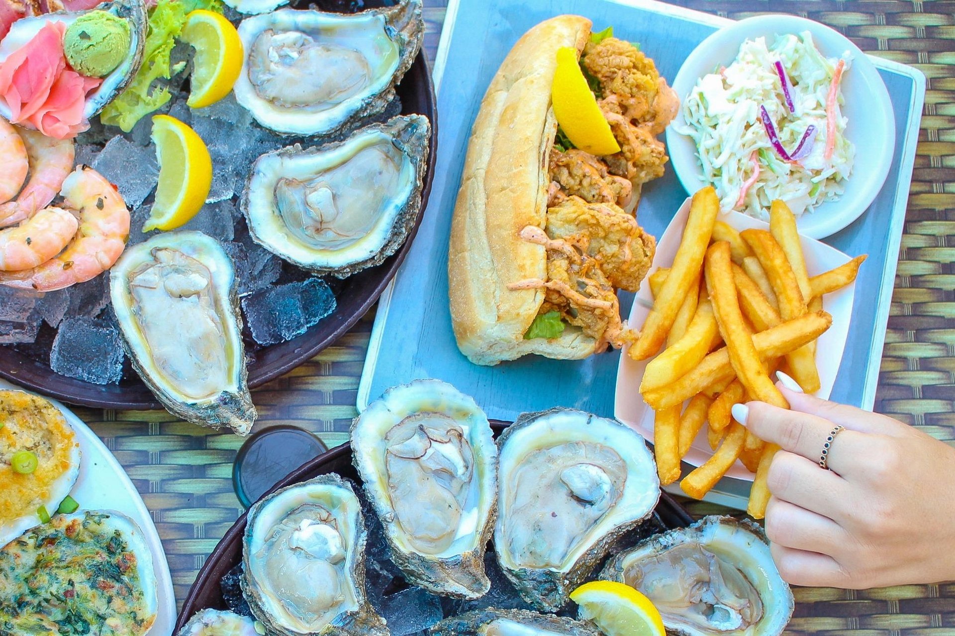 overhead view of various seafood dishes including oysters and shrimp